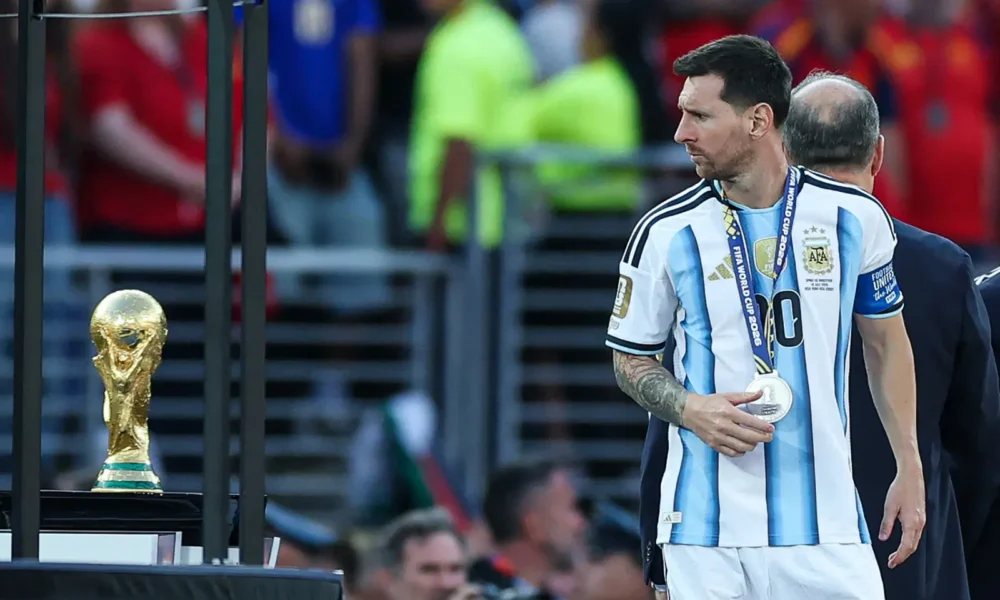 Argentina’s forward #10 Lionel Messi looks at the trophy after losing the 2026 World Cup football tournament final match between Spain and Argentina at the New York/New Jersey Stadium in East Rutherford on July 19, 2026. (Photo by PATRICIA DE MELO MOREIRA / AFP)