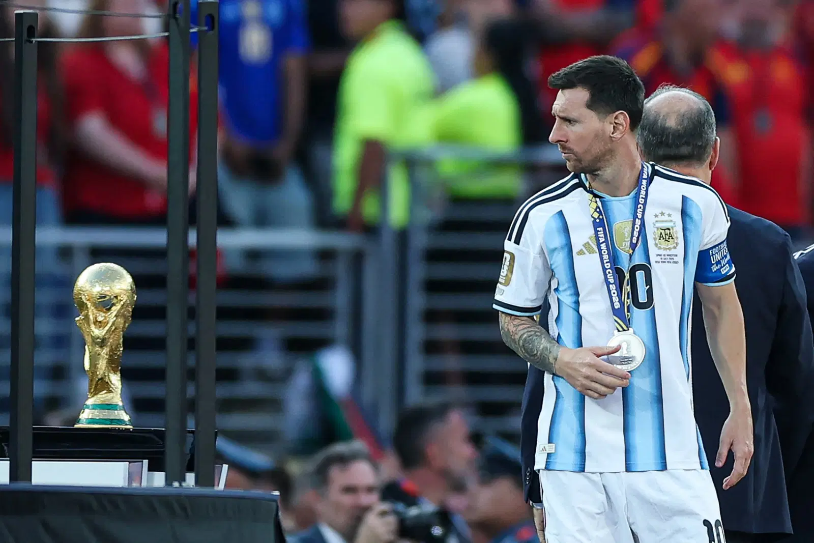 Argentina’s forward #10 Lionel Messi looks at the trophy after losing the 2026 World Cup football tournament final match between Spain and Argentina at the New York/New Jersey Stadium in East Rutherford on July 19, 2026. (Photo by PATRICIA DE MELO MOREIRA / AFP)