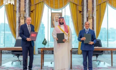 Turkish President Tayyip Erdogan, Saudi Crown Prince Mohammed bin Salman, and Pakistan's Prime Minister Shehbaz Sharif pose after signing a joint defence agreement in Mecca, Saudi Arabia, August 7, 2026.