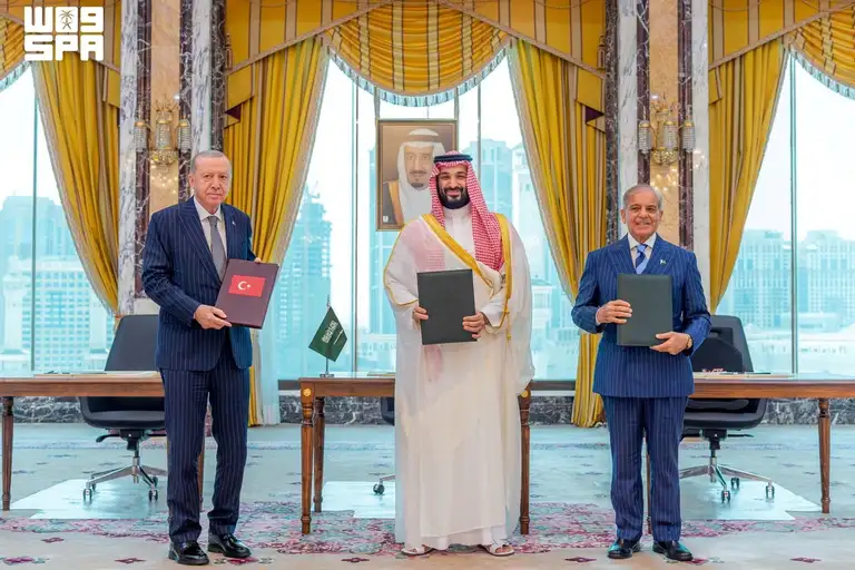 Turkish President Tayyip Erdogan, Saudi Crown Prince Mohammed bin Salman, and Pakistan's Prime Minister Shehbaz Sharif pose after signing a joint defence agreement in Mecca, Saudi Arabia, August 7, 2026.